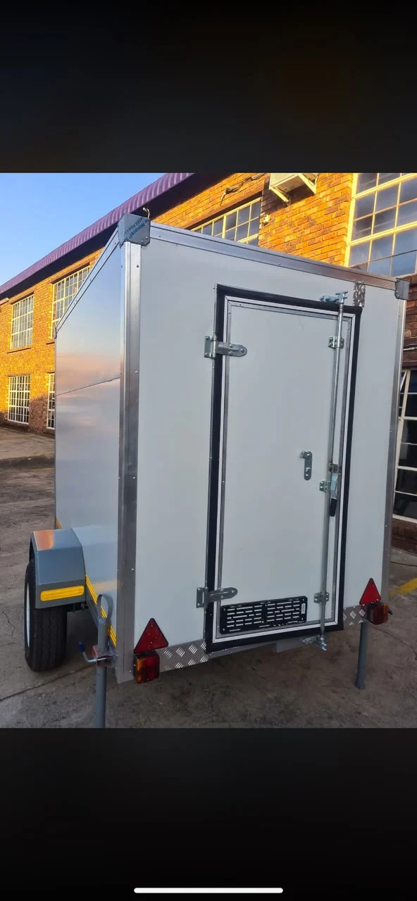 Mobile freezer trailer with insulated rear door