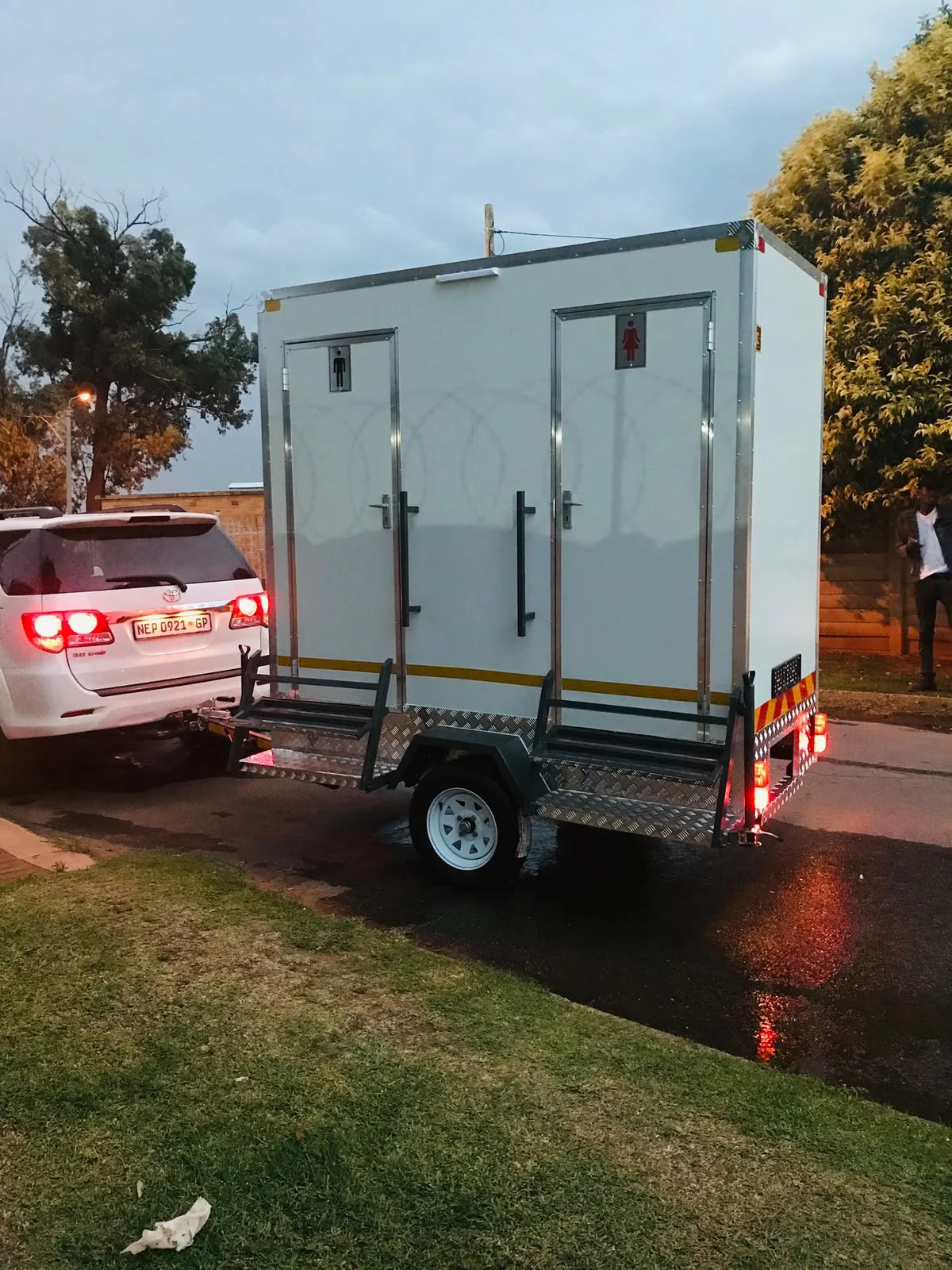 Mobile VIP toilet trailer with separate entrances and access steps